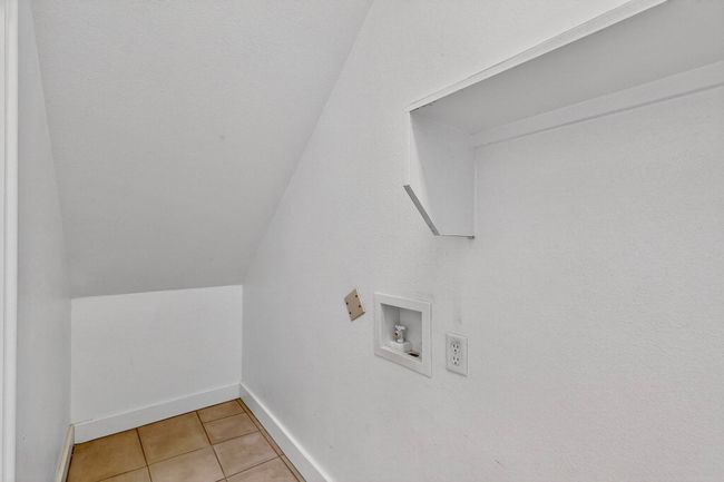 Laundry room with hookup for a washing machine and light tile patterned flooring | Image 34