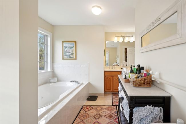 Bedroom featuring baseboards, carpet floors, and a baseboard radiator | Image 33
