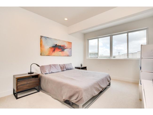 Bedroom with light colored carpet and recessed lighting | Image 16