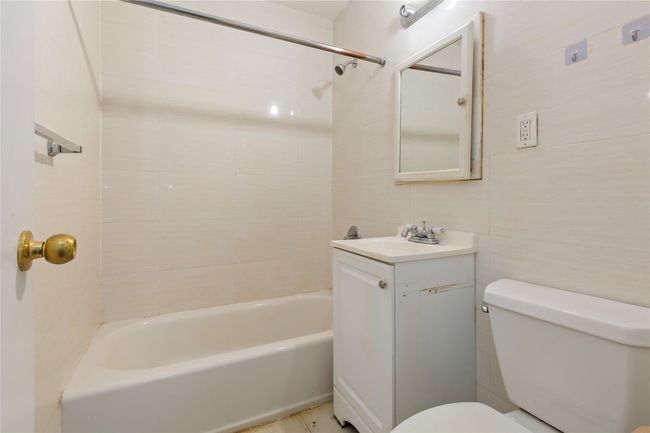 Full bath featuring vanity, tile walls, and shower combination | Image 12