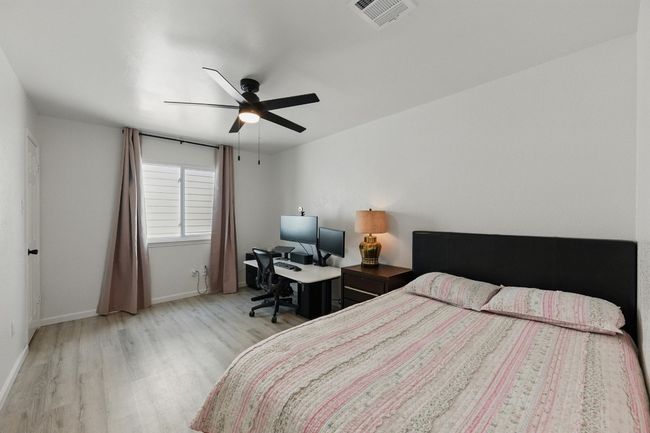 One of the guest rooms includes functional shelving in the closet, offering extra storage space for guests. | Image 24