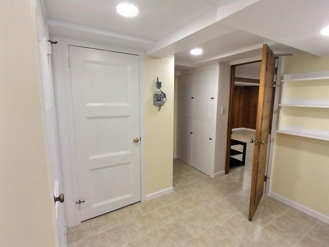 Hall featuring baseboards and light tile patterned flooring | Image 33
