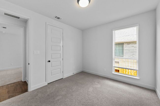 Unfurnished bedroom with carpet floors and wood finished floors | Image 20
