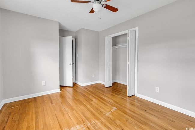 Unfurnished bedroom featuring light wood-type flooring, a closet, and a ceiling fan | Image 27