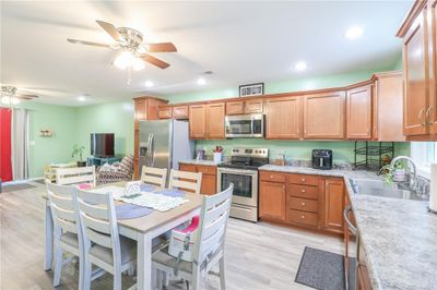 Kitchen featuring sink, appliances with stainless steel finishes, light wood-type flooring, and ceiling fan | Image 2