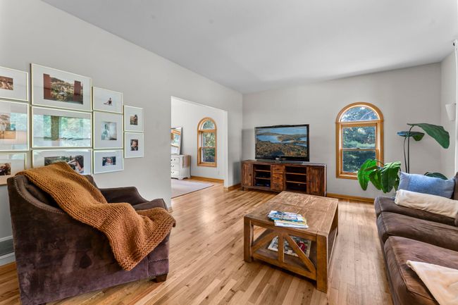 Rich wood flooring adds warmth and durability, creating a space that’s both stylish and functional. Whether you're hosting guests or enjoying a cozy night in, this room sets the tone for relaxed, comfortable living. | Image 4