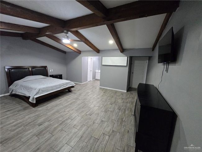 Bedroom featuring baseboards, wood finished floors, and recessed lighting | Image 6