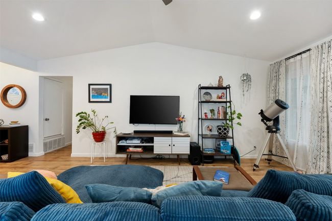 Living area featuring lofted ceiling, wood finished floors, visible vents, and recessed lighting | Image 10