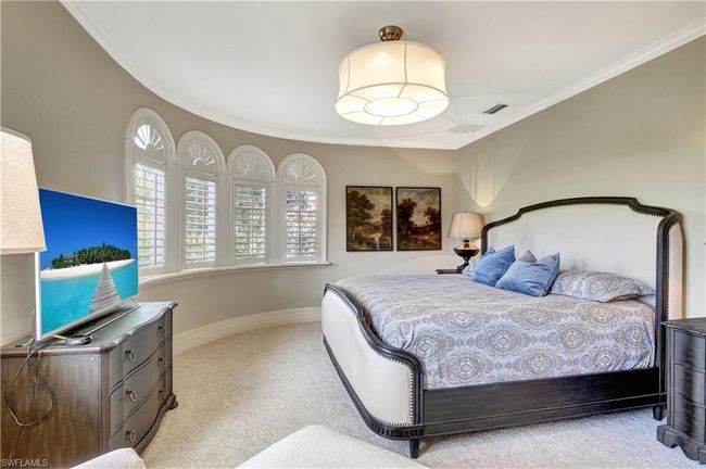 Carpeted bedroom featuring baseboards, visible vents, and crown molding | Image 12