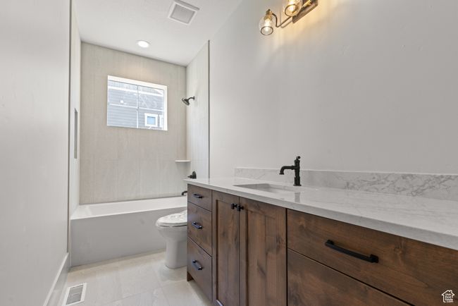 Full bath featuring vanity and shower / tub combination | Image 16