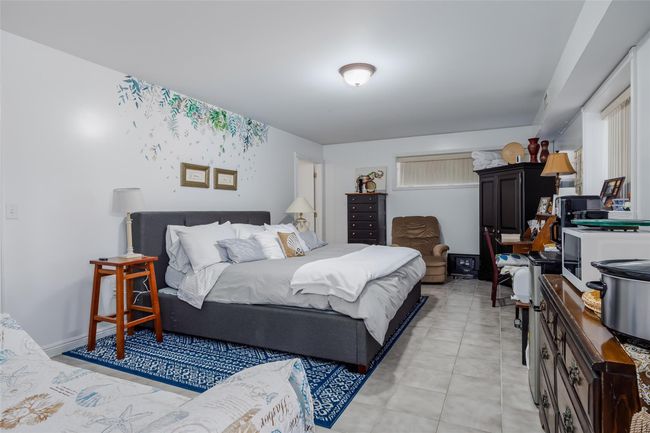 Bedroom with light tile patterned floors and baseboards | Image 28