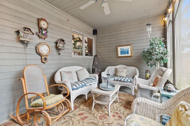 Screened in porch showing pass through to kitchen. | Image 19