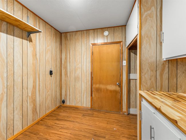 Washroom with wooden walls and light wood-type flooring | Image 24