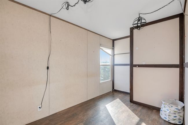 Spare room featuring wood finished floors | Image 35