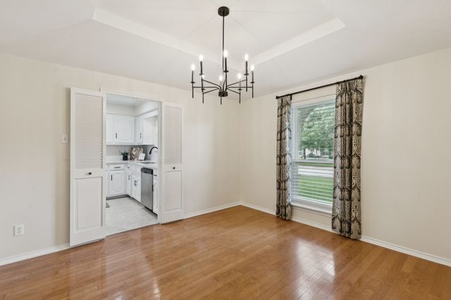 Formal Dining Area with New stylish chandelier and engineered hardwood flooring | Image 6