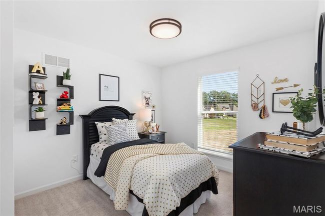 Bedroom featuring light carpet and baseboards | Image 4