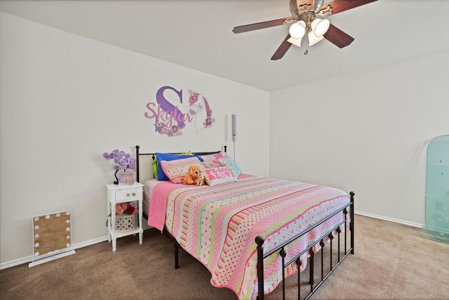 Bedroom with carpet flooring and a ceiling fan | Image 19