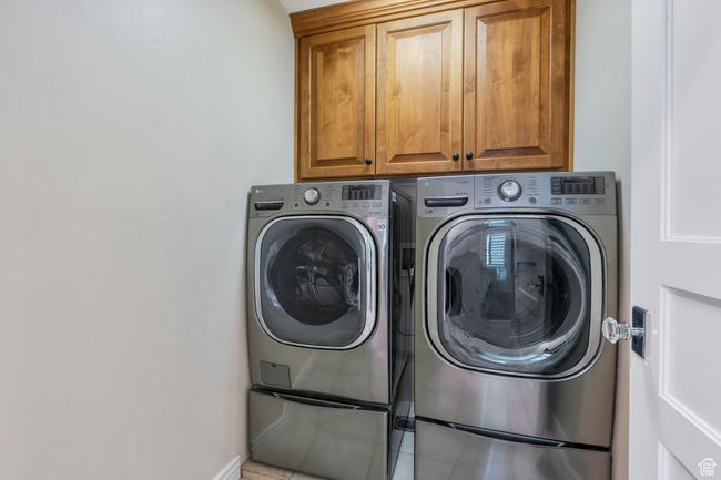 Laundry room with washing machine and dryer, cabinet space, and baseboards | Image 28