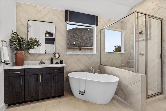 Bathroom featuring a shower stall, a soaking tub, and vanity | Image 13
