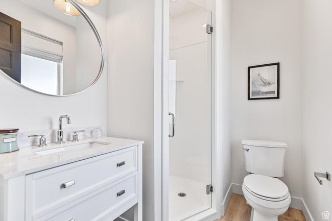 Full bathroom with toilet, a stall shower, wood finished floors, and vanity | Image 50