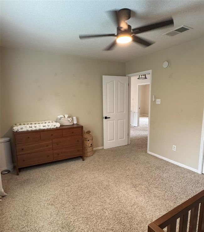 Upstairs Guest Bedroom #3 with light carpet, a textured ceiling, and ceiling fan. | Image 23
