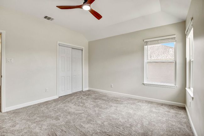 bedroom 2 with ceiling fan and natural light | Image 13