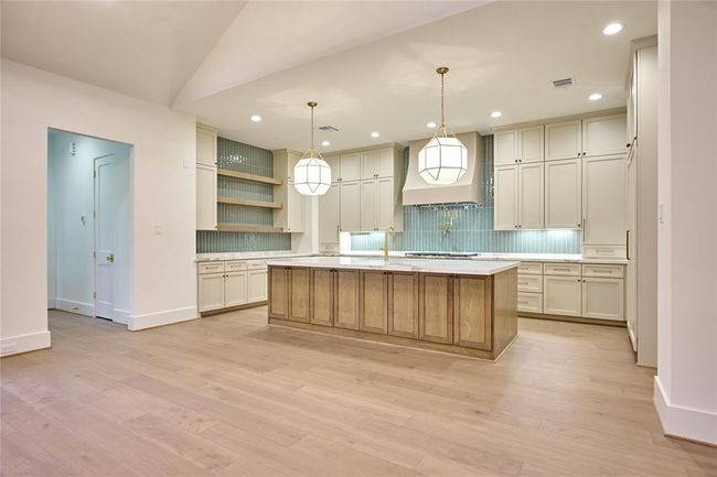 This kitchen features abundant storage with custom made cabinetry crafted by Kent Moore. | Image 15