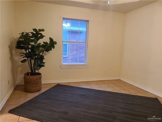 Spare room featuring light tile patterned floors and baseboards | Image 8