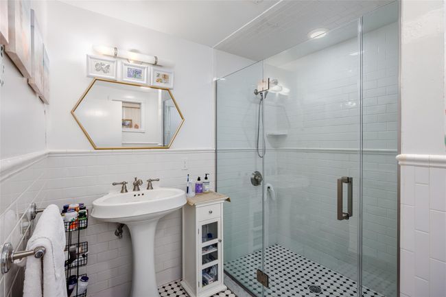 Full bath with a wainscoted wall, a shower stall, and tile walls | Image 27