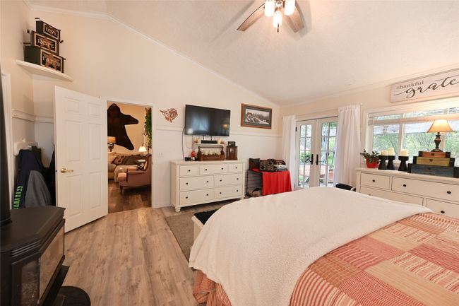 Bedroom featuring french doors, access to exterior, ornamental molding, vaulted ceiling, and light wood-style flooring | Image 30
