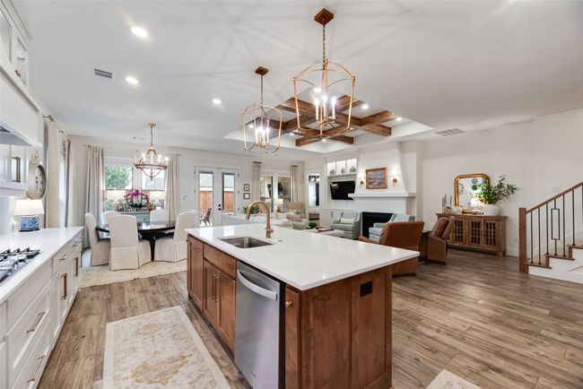 Kitchen featuring a chandelier, stainless steel appliances, recessed lighting, a sink, and light wood-style floors | Image 11