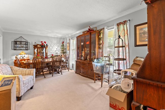 Living room featuring crown molding, carpet floors, and a textured ceiling | Image 10