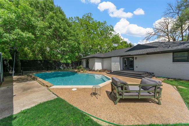 View of swimming pool with french doors and a patio area | Image 17