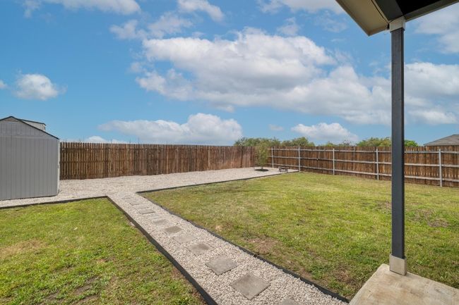 View of yard with an outdoor structure, a fenced backyard, and a storage shed | Image 30