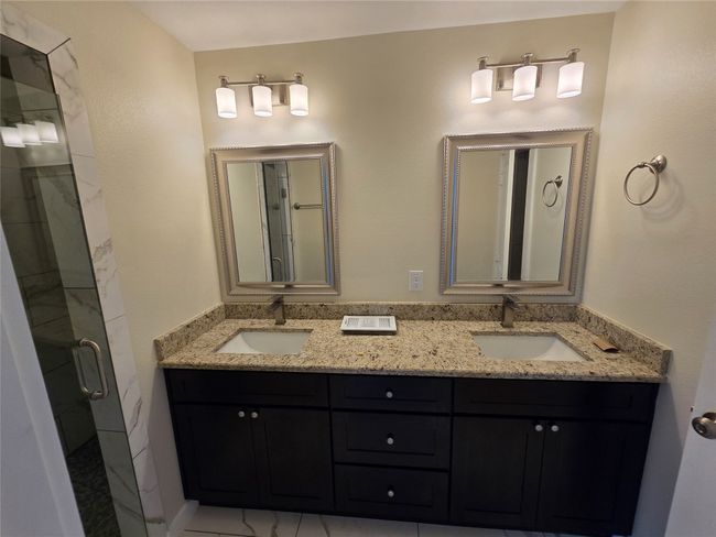 Full bath featuring a shower stall and double vanity | Image 24