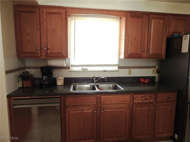 Kitchen features stainless steel Dishwasher & Stainless sink with Solid Oak Cabinets. | Image 10