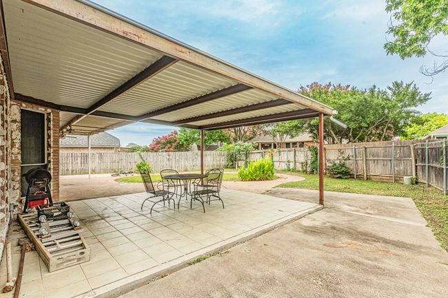 Fenced backyard featuring a patio and outdoor dining area | Image 34