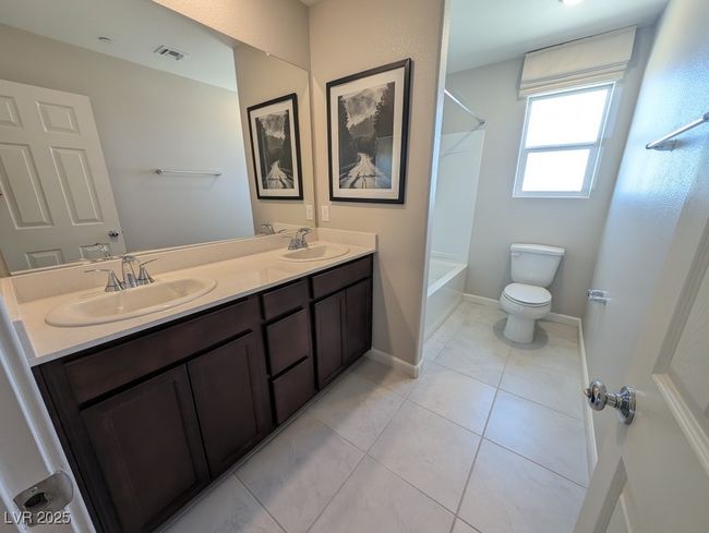 Full bath with double vanity, shower / washtub combination, and tile patterned flooring | Image 34