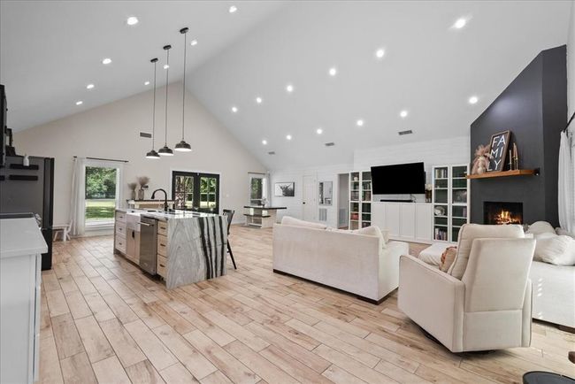 Breathtaking open layout with vaulted ceilings, custom lighting, and seamless flow between kitchen and living areas. | Image 16