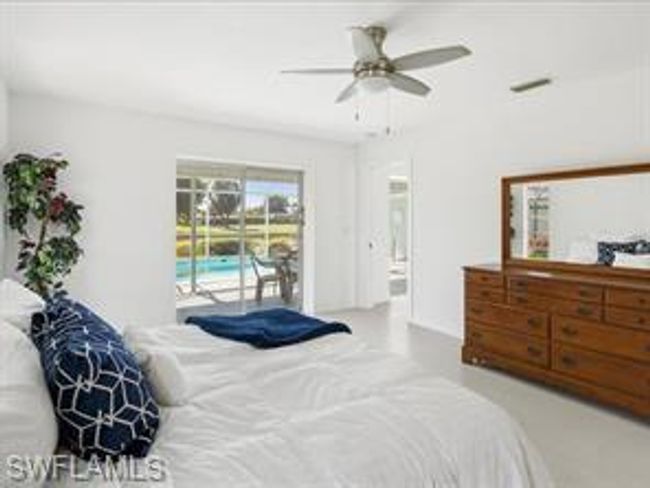 Bedroom featuring ceiling fan and access to exterior | Image 12