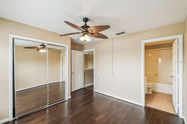 The second upstairs bedroom offers an en-suite bathroom with a shower/tub combo and a serene view of the pond. | Image 20