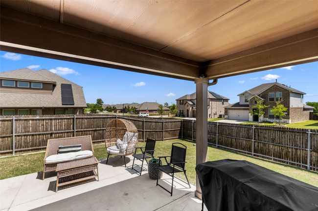 View of patio with a fenced backyard, a grill, and a residential view | Image 31