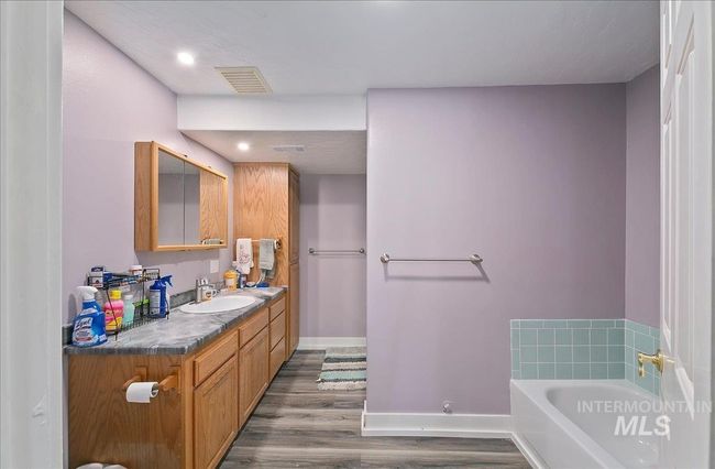 Full bathroom with wood finished floors, a bath, vanity, and recessed lighting | Image 29