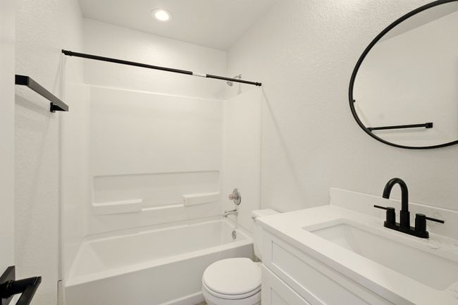 Guest Bathroom with single vanity, shaker cabinetry & tub | Image 15