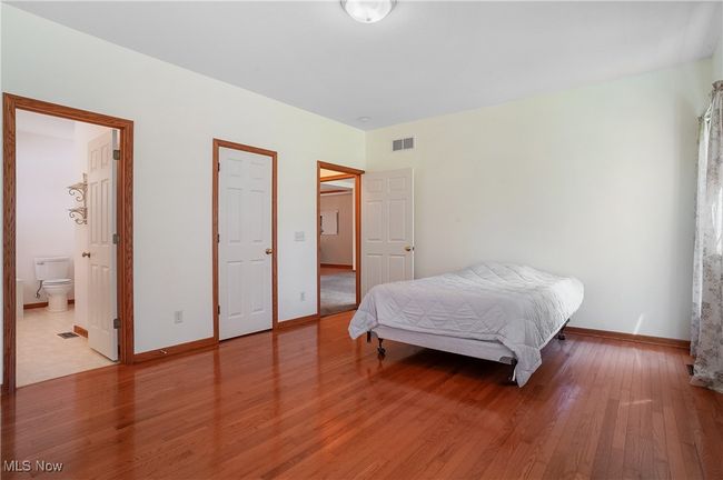 Bedroom featuring light wood-style flooring, visible vents, and baseboards | Image 31
