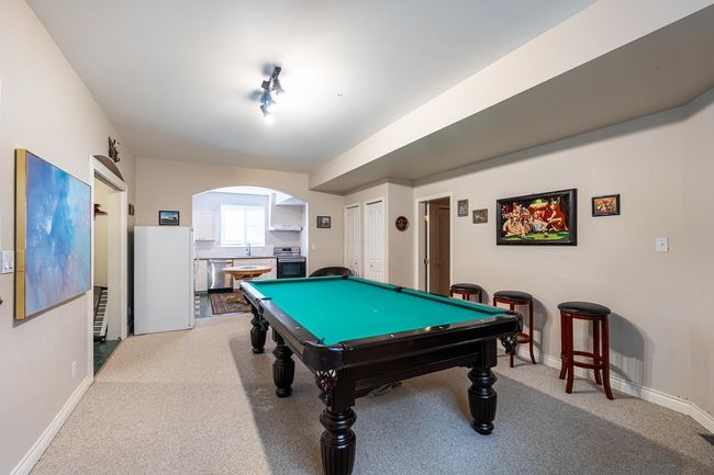 Game room with baseboards, pool table, carpet, and a sink | Image 32