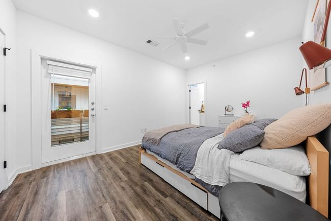 Bedroom featuring wood finished floors, baseboards, visible vents, ceiling fan, and recessed lighting | Image 19