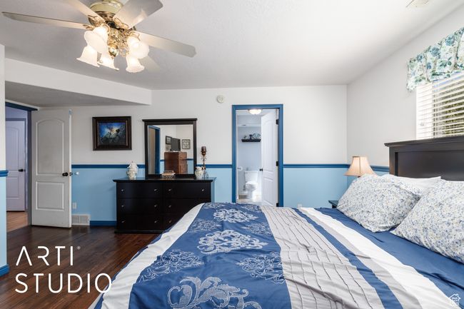 Bedroom with wood finished floors, ceiling fan, and ensuite bath | Image 22