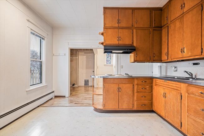 Kitchen featuring backsplash, baseboard heating, and sink | Image 10
