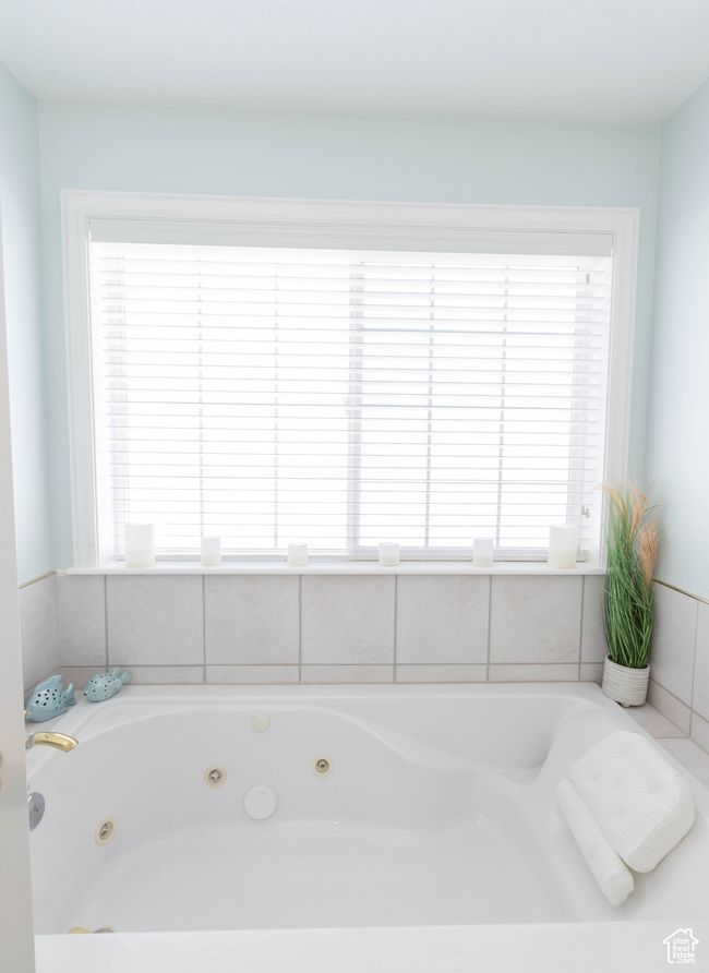 Bathroom featuring plenty of natural light and a whirlpool tub | Image 18